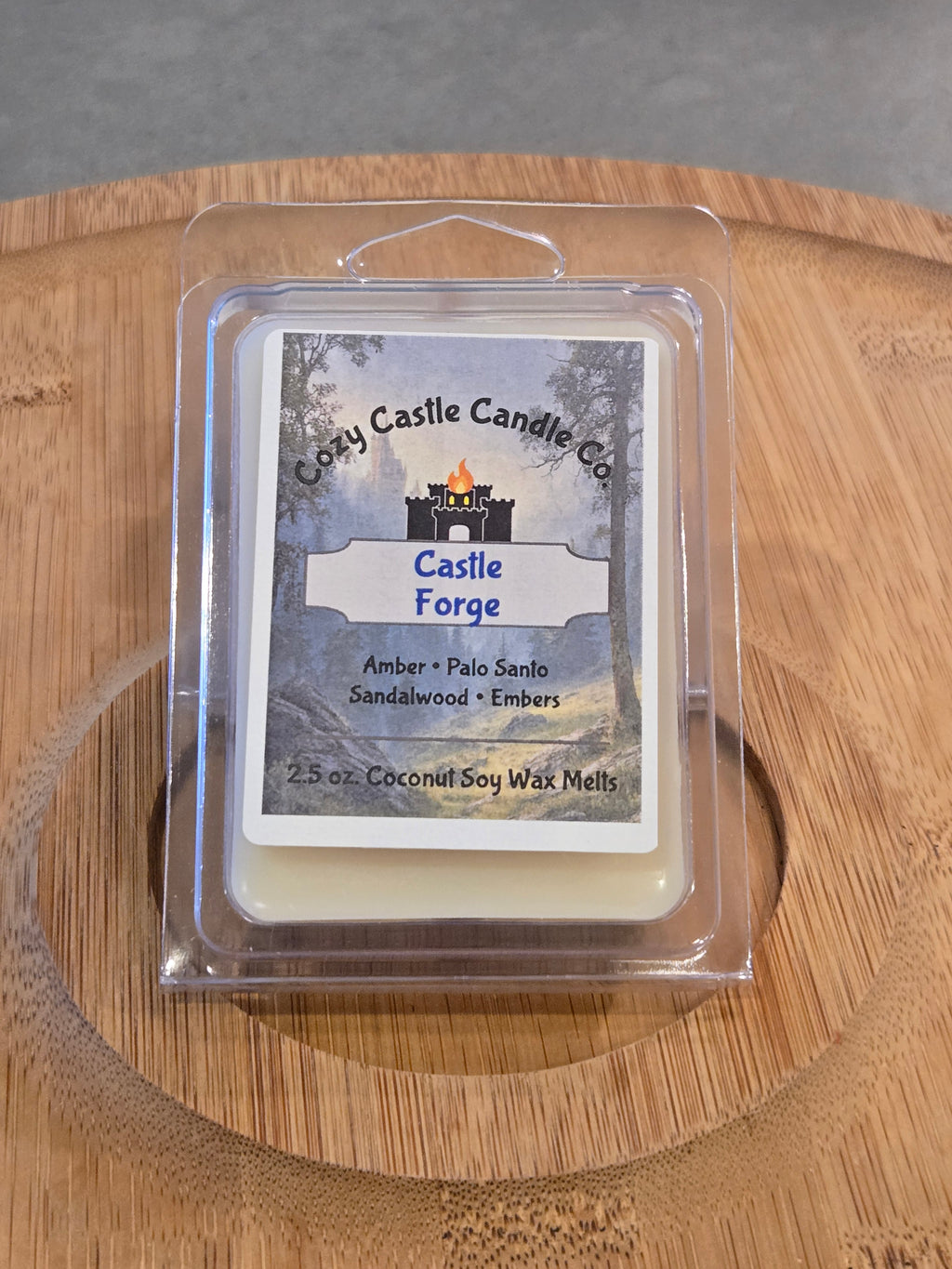 Wax Melts labeled "Castle Forge" on a textured wooden surface.