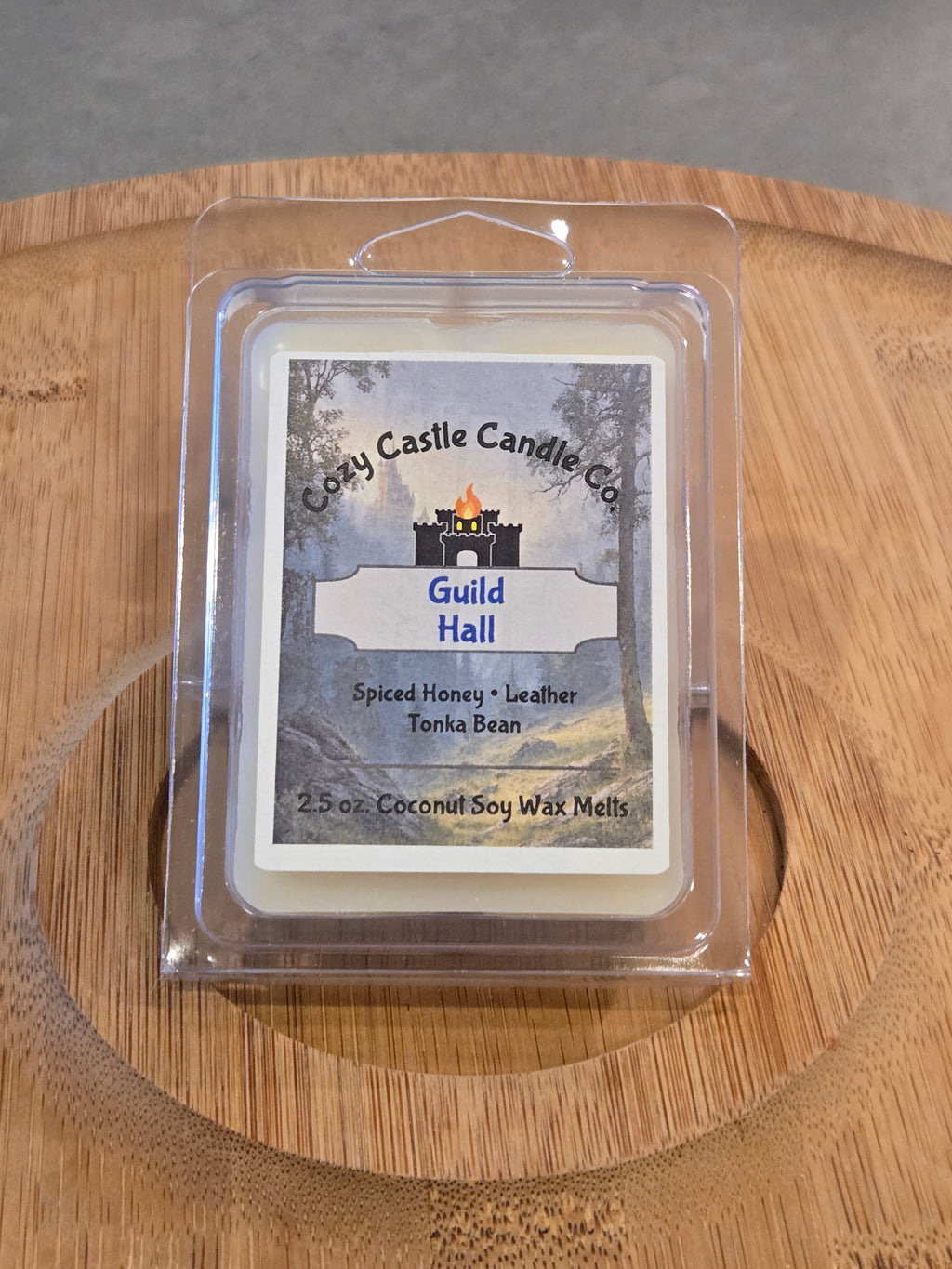 Wax Melts labeled "Guild Hall" on a textured wooden surface.