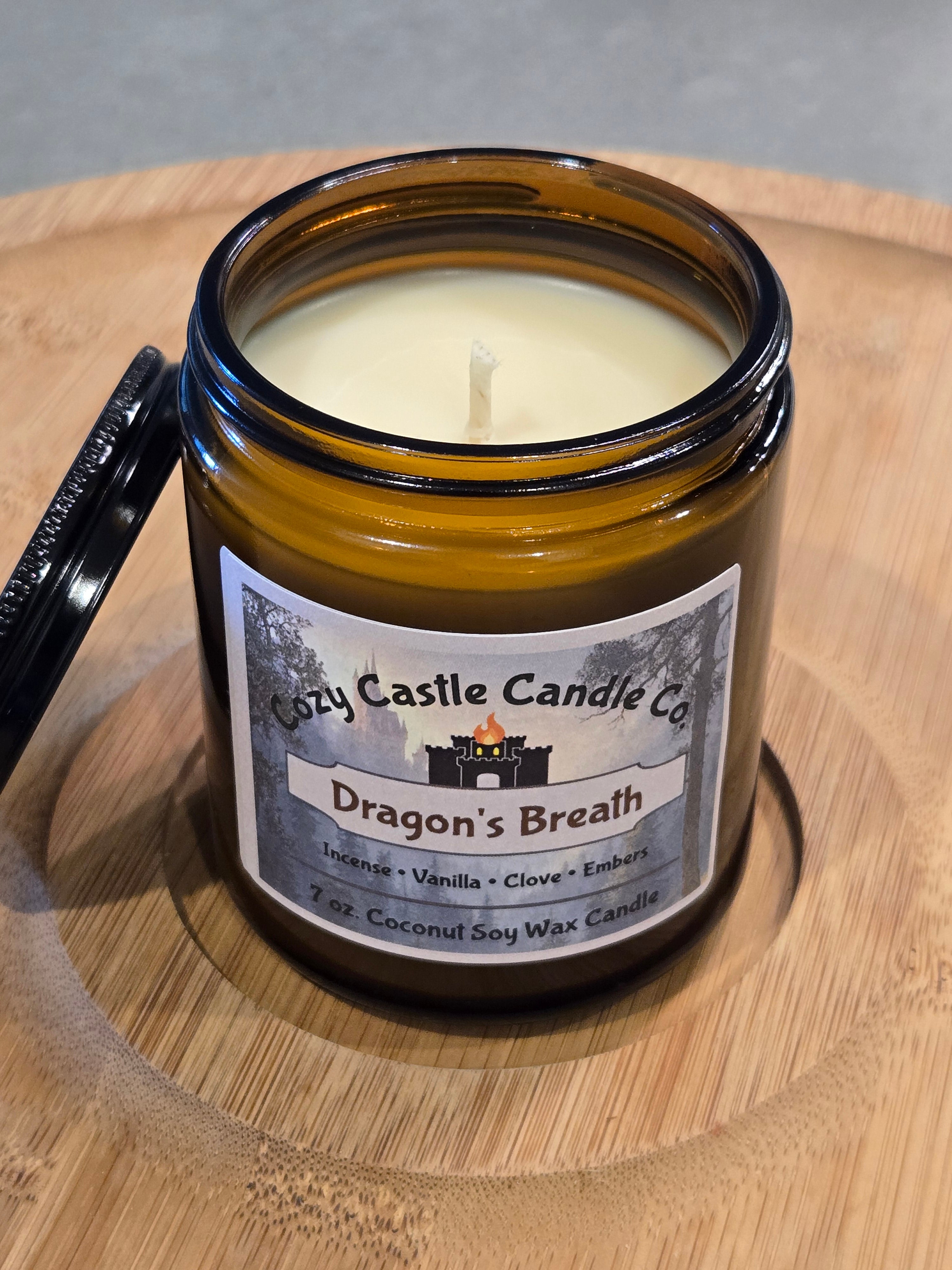Candle labeled "Dragons Breath" on a textured wooden surface.